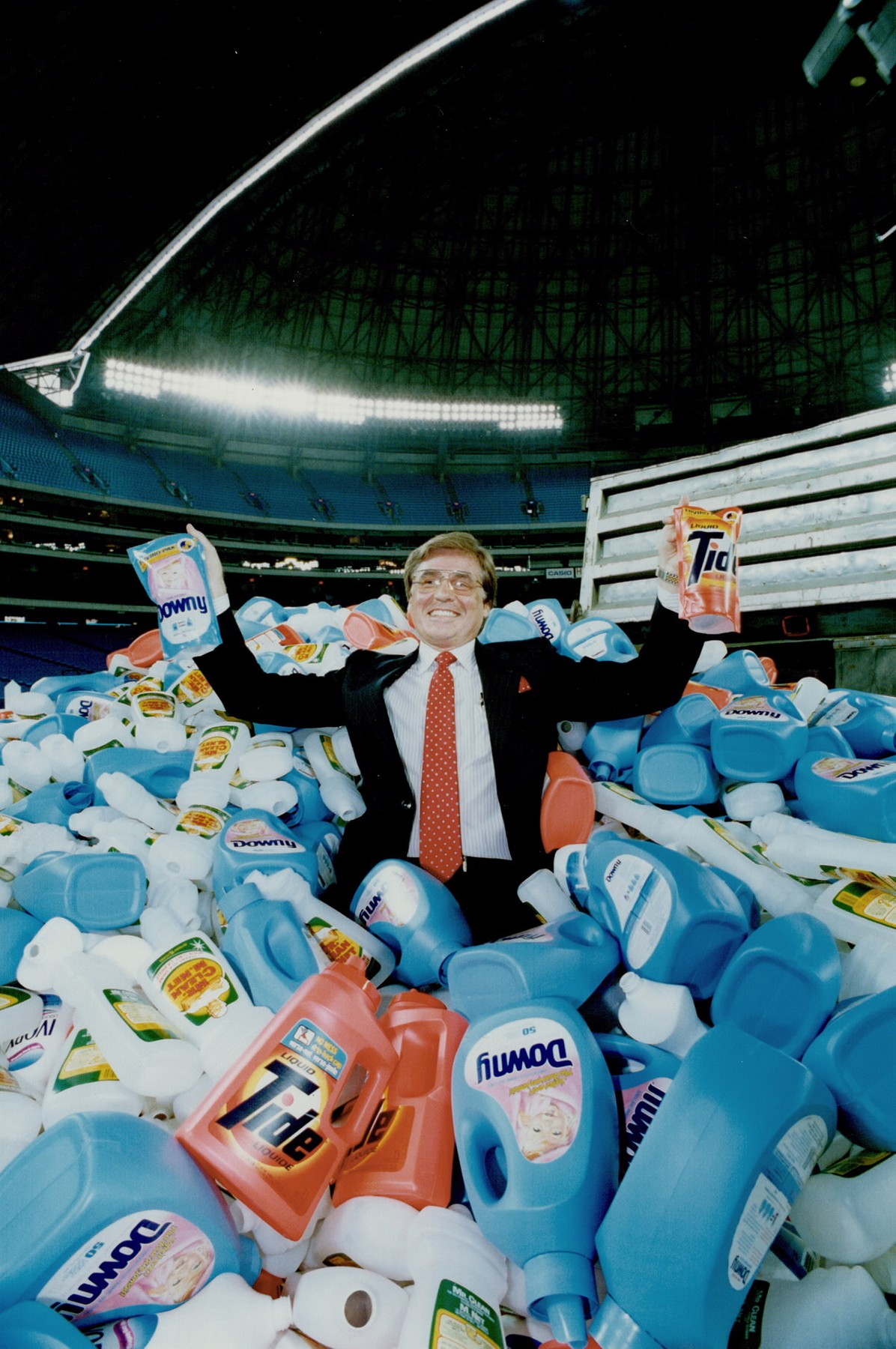 Waste not: Douglas Grindstaff on the SkyDome field, amid discarded plastic bottles. Right, he shows how they can be refilled.