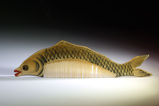 Traditional translucent painted horn comb of a perch