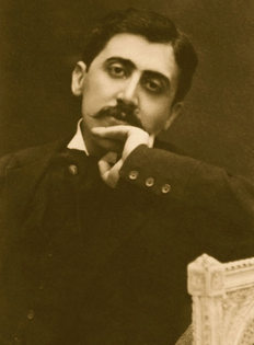 sepia toned old photograph of mustachioed man with dark features and searching eyes, resting his chin on his hand. 