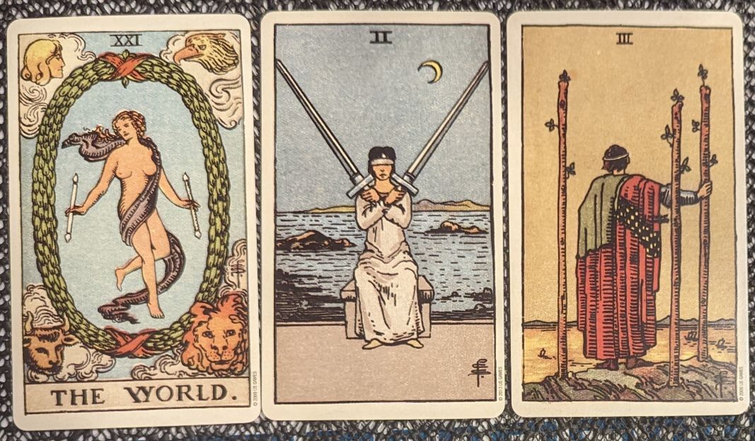 the world + two of swords + three of wands