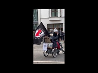 Αntifa lady on a tricycle greets fascists and cops with her middle finger (Leipzig, Germany)